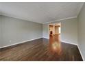 Neutral living room with hardwood floors and open doorway to the den at 2068 Signal Ridge Nw, Kennesaw, GA 30152