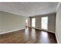 Cozy living room featuring hardwood floors and natural light from two large windows at 2068 Signal Ridge Nw, Kennesaw, GA 30152
