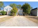 Inviting two-story home with brick accents, lush trees, and a lengthy driveway at 3652 Platina Park Ct, Decatur, GA 30034