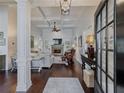 Grand entryway showcases hardwood floors, coffered ceilings, and elegant details creating a welcoming atmosphere for guests at 3174 Piney Woods Cir, Buford, GA 30519
