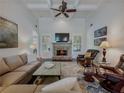 Cozy living room features a stone fireplace, hardwood floors, and coffered ceilings for a luxurious and comfortable ambiance at 3174 Piney Woods Cir, Buford, GA 30519