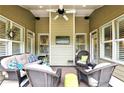 Inviting outdoor living space featuring comfortable seating and a ceiling fan for relaxation and enjoying outdoor living at 3174 Piney Woods Cir, Buford, GA 30519