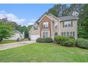 Traditional two-story home featuring brick and siding with a well-manicured front lawn and an attached two-car garage at 3885 Weeping Willow Ln, Loganville, GA 30052