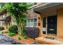 Beautiful brick facade featuring stone accents, a front door with glass and brick steps, enhancing its curb appeal at 120 Biscayne Nw Dr # C13, Atlanta, GA 30309