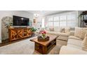 Inviting living room with large windows, neutral walls, stylish furniture and light-colored sofa, creating a cozy atmosphere at 120 Biscayne Nw Dr # C13, Atlanta, GA 30309