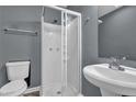 Compact bathroom featuring a pedestal sink and glass enclosed standing shower stall at 1911 Rosewood Rd, Decatur, GA 30032