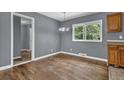Dining area boasts hardwood floors, a modern light fixture, and natural light at 1911 Rosewood Rd, Decatur, GA 30032