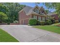 Lovely home featuring a three-car garage and a long driveway at 765 Vinings Estates Se Dr, Mableton, GA 30126