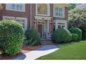 Inviting front entrance featuring a brick walkway and manicured landscaping at 765 Vinings Estates Se Dr, Mableton, GA 30126