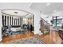 Bright living room featuring elegant decor, hardwood floors and a staircase at 765 Vinings Estates Se Dr, Mableton, GA 30126