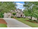 Long driveway leading to a two-story home with well-maintained lawn and landscaping at 1942 N Akin Ne Dr, Atlanta, GA 30345