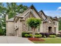 Exterior elevation of home showing side-entry garage and well maintained landscaping at 1942 N Akin Ne Dr, Atlanta, GA 30345