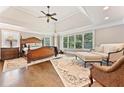 Serene main bedroom with tray ceiling, large windows, hardwood floors, and sitting area at 3456 Glen Mist Pl, Dacula, GA 30019