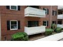Balconies with white railings, brick exterior, and black shutters add charm to this condo at 107 Ridley Howard Ct, Decatur, GA 30030