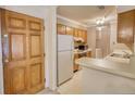 Traditional kitchen with wood cabinets, white appliances, and breakfast bar provides a functional space at 107 Ridley Howard Ct, Decatur, GA 30030