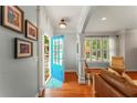 Welcoming foyer with hardwood floors, bright blue door, and stylish decor at 1560 Gilstrap Nw Ln, Atlanta, GA 30318