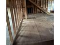 Unfinished basement with exposed framing, subfloor, and access to upper level at 2079 Bencal Se Dr, Atlanta, GA 30316