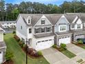 Aerial view showcasing the beautiful landscaping of this well-maintained two-story townhome community at 2089 Lanier Harbor Pt # 2089, Buford, GA 30518