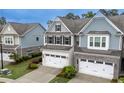 A high angle view of this lovely two-story townhome, with its well-kept lawn and landscaping at 2089 Lanier Harbor Pt # 2089, Buford, GA 30518