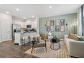 Modern living room with white kitchen in the background, breakfast bar and stylish decor and art pieces at 2364 Haran Dr # 35, Lithonia, GA 30058