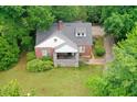 Aerial view of the brick home showcasing its lush green lawn and surrounding mature landscaping at 338 Candler Rd, Atlanta, GA 30317