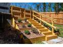 Tiered wooden staircase with built-in planters, adding character and functionality to the outdoor space at 1105 Gun Club Nw Rd, Atlanta, GA 30318