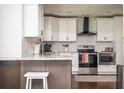 Modern kitchen featuring sleek white cabinets, granite countertops, and stainless steel appliances at 1105 Gun Club Nw Rd, Atlanta, GA 30318