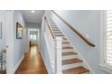 Bright hallway with hardwood floors and staircase leading to the upper level at 1810 Annie Nw St, Atlanta, GA 30318