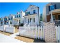 Charming two-story home with white picket fence and inviting front porch, and landscaped yard at 458 Bishop Ln, Woodstock, GA 30188