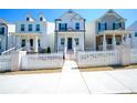 Charming two-story home with white picket fence and inviting front porch, and landscaped yard at 458 Bishop Ln, Woodstock, GA 30188