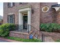 Close-up of the home's entry, showing a decorative metal railing and brick steps at 609 Pinetree Dr, Decatur, GA 30030