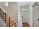 Bright entryway with hardwood floors, staircase, and white paneled doors at 609 Pinetree Dr, Decatur, GA 30030