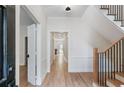 Inviting hallway with hardwood floors, staircase, and white trim details at 609 Pinetree Dr, Decatur, GA 30030