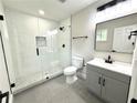Updated bathroom featuring a glass-enclosed shower, modern fixtures, and stylish gray vanity at 6205 Hudson Nw St, Covington, GA 30014