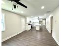 Bright open-concept living room flowing into a modern kitchen, enhanced by updated flooring at 6205 Hudson Nw St, Covington, GA 30014