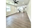 Open-concept living room showcasing new floors and ample natural light, adjacent to a modern kitchen at 6205 Hudson Nw St, Covington, GA 30014