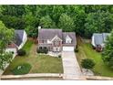 Aerial view of a two-story home with lush green surroundings and a well-maintained lawn in a serene neighborhood at 2086 Grant Ave, Mcdonough, GA 30252