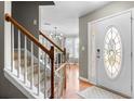 Inviting foyer with hardwood floors, staircase, and a view into the dining room at 2086 Grant Ave, Mcdonough, GA 30252