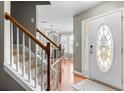 Inviting foyer with hardwood floors, staircase, and a view into the adjacent dining area with modern chandelier at 2086 Grant Ave, Mcdonough, GA 30252