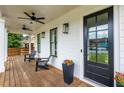 Inviting front porch features stylish seating, ceiling fans, and a sleek black front door at 437 E Ontario Sw Ave, Atlanta, GA 30310