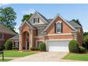 Gorgeous brick home features a well-maintained lawn, two-car garage, and classic black shutters, radiating curb appeal at 4769 Ellington Ct, Marietta, GA 30067