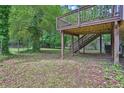 View of the backyard and an elevated wooden deck with access stairs at 5295 Old Trail Cir, Stone Mountain, GA 30088