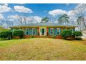 Attractive brick home with beautiful blue shutters and a well-maintained lawn at 118 Heritage Way, Peachtree City, GA 30269