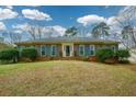Attractive brick home with beautiful blue shutters and a well-maintained lawn at 118 Heritage Way, Peachtree City, GA 30269
