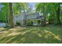 Attractive front yard features stone accents, a red door, and mature landscaping at 2162 Brookview Nw Dr, Atlanta, GA 30318
