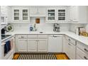 All-white kitchen with white cabinetry and a complementary white tiled backsplash at 1634 Ponce De Leon Ne Ave # 208, Atlanta, GA 30307