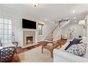 Cozy living room featuring a fireplace, hardwood floors, and staircase at 183 Whitefoord Ne Ave, Atlanta, GA 30307