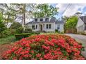 Charming home exterior with brick accents, lush landscaping, and colorful azalea bushes at 2840 Alpine Rd, Atlanta, GA 30305