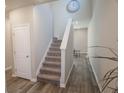 Entryway with gray walls, staircase, and wood look flooring leading into the home at 109 Auburn Crossing Dr, Auburn, GA 30011