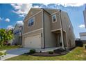 Two-story home with gray siding, small landscaped yard, and a two car garage at 109 Auburn Crossing Dr, Auburn, GA 30011